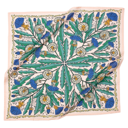 A multicolored bandana with a floral pattern, predominantly in shades of blue and green, laid out.