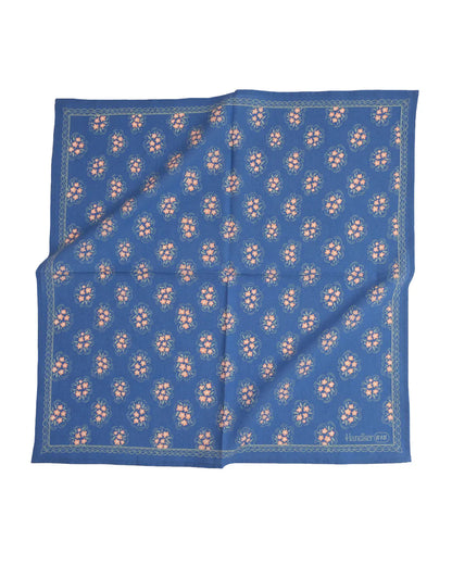 Pink floral pattern on blue bandana laying flat on a white background